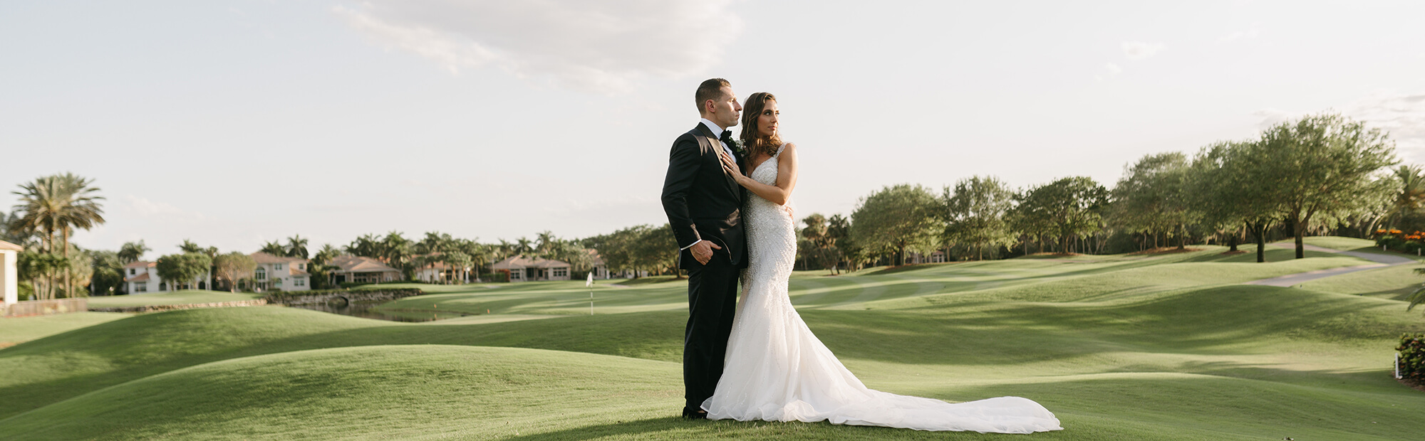 bride and groom on golf course